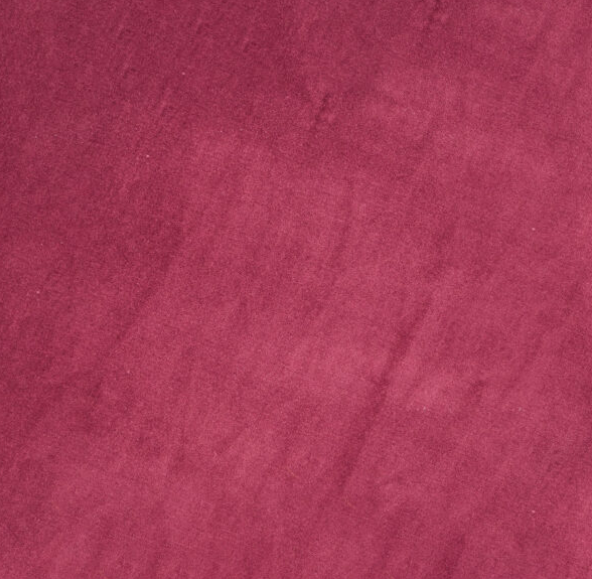 A close-up view of a soft, textured surface in a solid, deep reddish-pink color with subtle variations and faint diagonal lines.