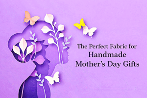 Paper art silhouette of a woman and child with leaves and butterflies on a purple background. Text reads, “The Perfect Fabric for Handmade Mother’s Day Gifts.”.