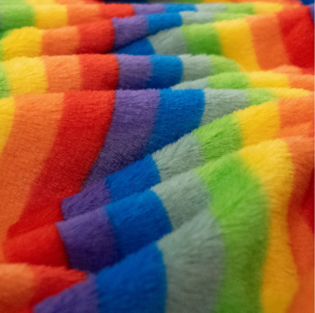 Close-up of cutting Rainbow Fur fabric from the backing correctly